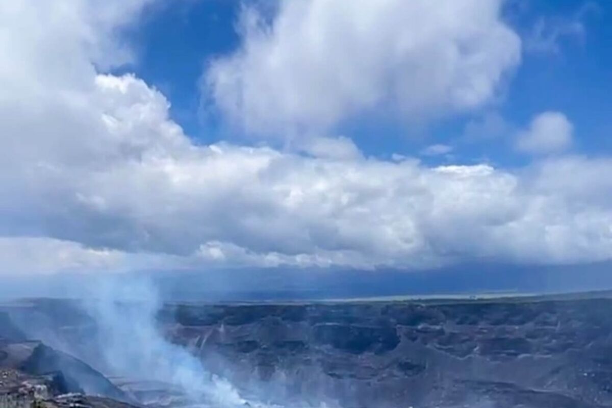 An%20active%20volcano%20in%20the%20distance%20on%20the%20edge%20of%20a%20cliff%20during%20the%20day%2E