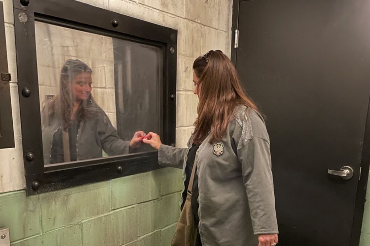 woman%20in%20jail%20cell%20looking%20at%20mirror