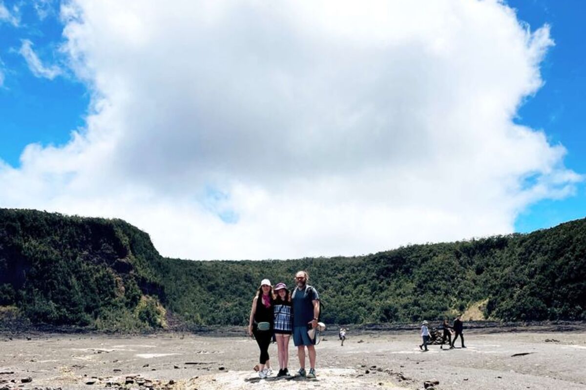 Three%20people%20walking%20through%20a%20Volcano%20caldera%20in%20the%20daytime%2E