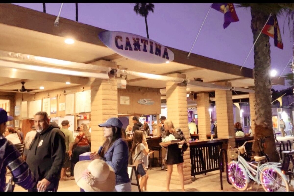 Front%20of%20The%20Campland%20Cantina%20restaurant%20with%20people%20walking%20by%2E