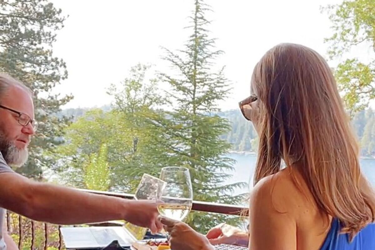 Couple%20sitting%20on%20balcony%20eating%20charcuterie%20and%20drinking%20wine