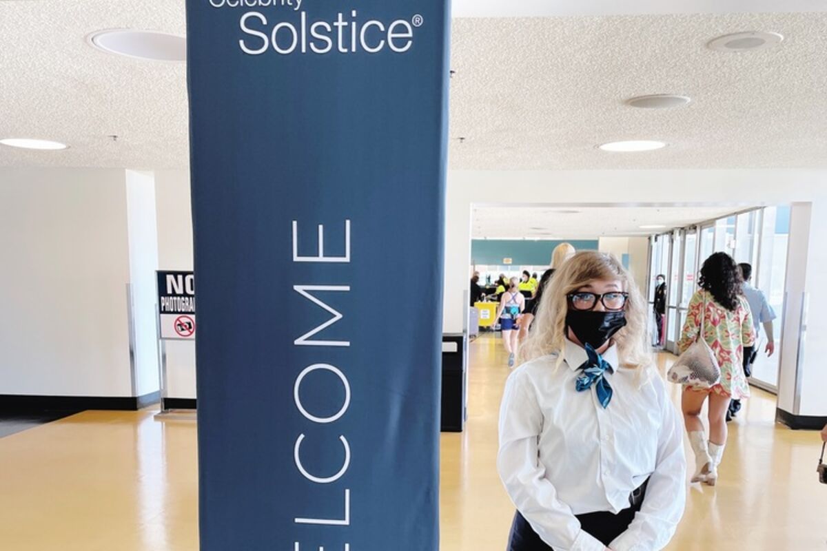 Woman%20next%20to%20a%20sign%20Welcome%20to%20the%20Celebrity%20Solstice%20Cruise